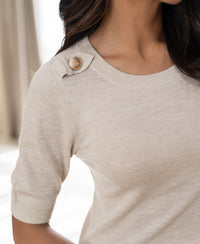 Beige merino wool sweater with epaulette-style shoulder button detail.