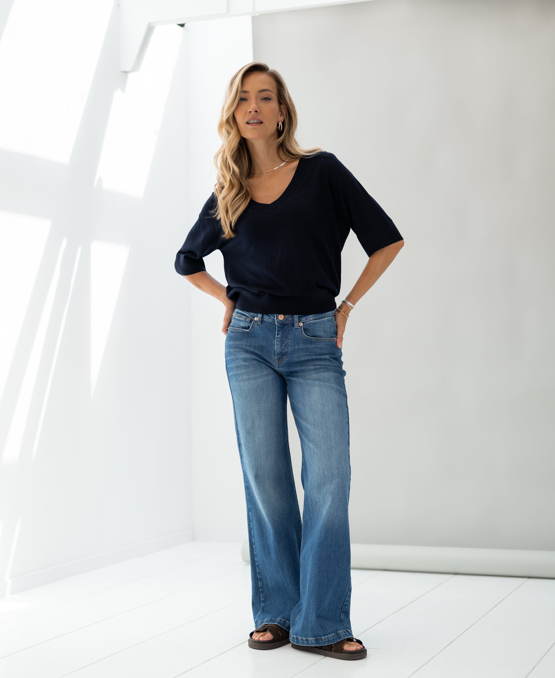 Navy blue silk blend top by PLEIN PUBLIQUE shown in a bright, minimalist room.