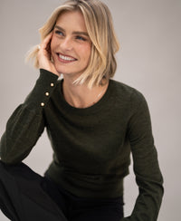 Dark green and gold PLEIN PUBLIQUE LA MARIS merino wool sweater, shown on model against a neutral background.