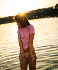 Light pink Luxe & soft T-shirt in shallow water at sunset.