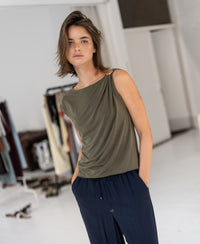 Olive green PLEIN PUBLIQUE LA MAYA top with buckle, shown in a bright room.