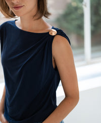Woman wearing the LA MAYA Dark Blue Top with clasp by PLEIN PUBLIQUE.
