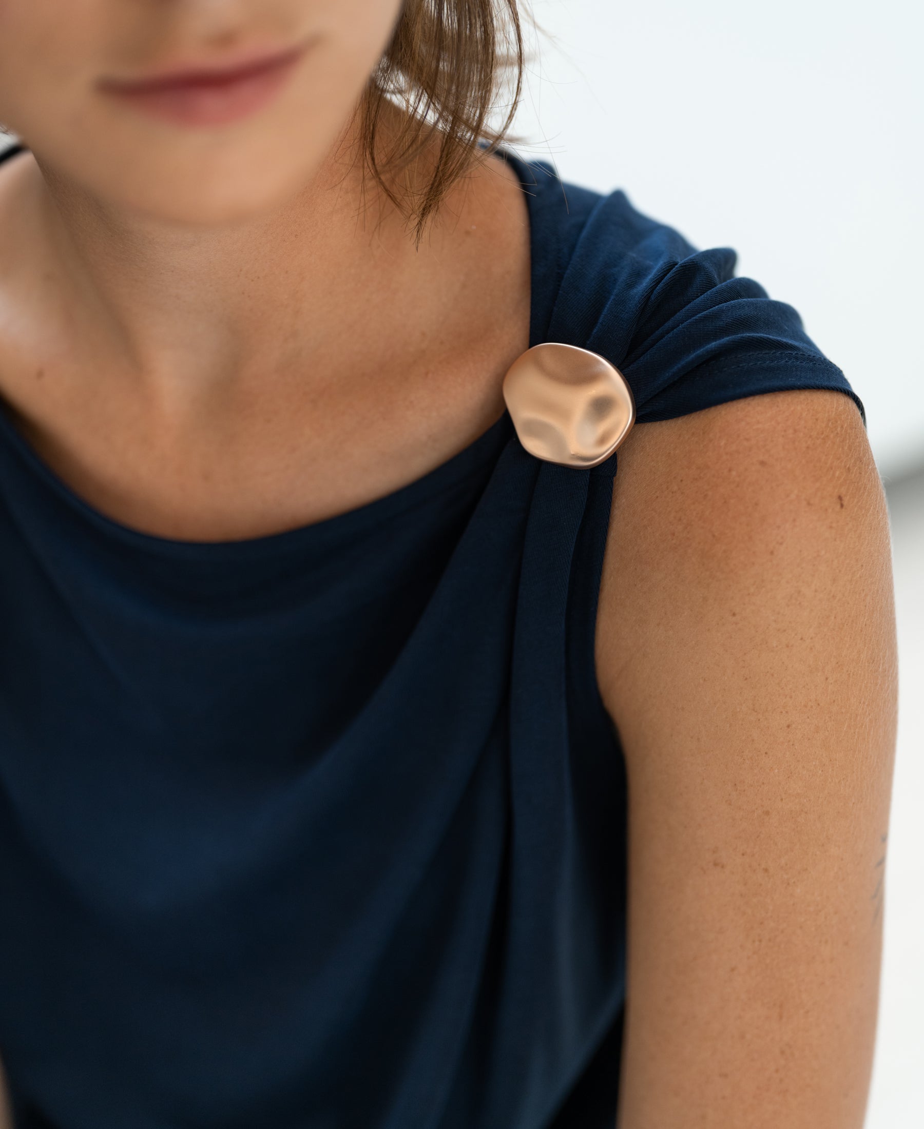 Shoulders-up view of the PLEIN PUBLIQUE LA MAYA top with buckle detail in dark blue.