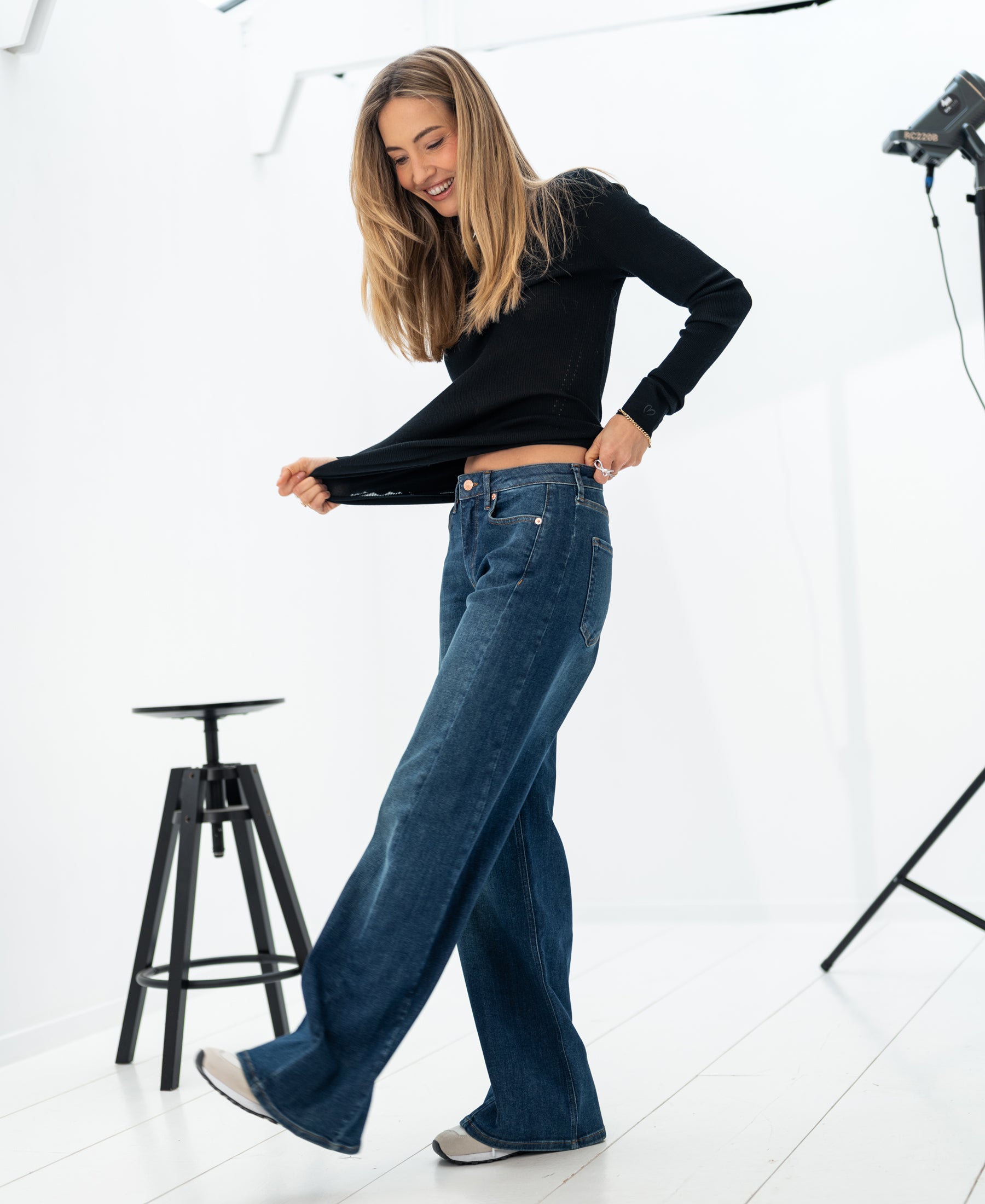 Wide leg blue heritage jeans in a bright studio.