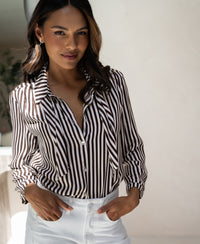 Ivory-cocoa striped PLEIN PUBLIQUE blouse with tie detail, LA MINOU style, shown indoors.