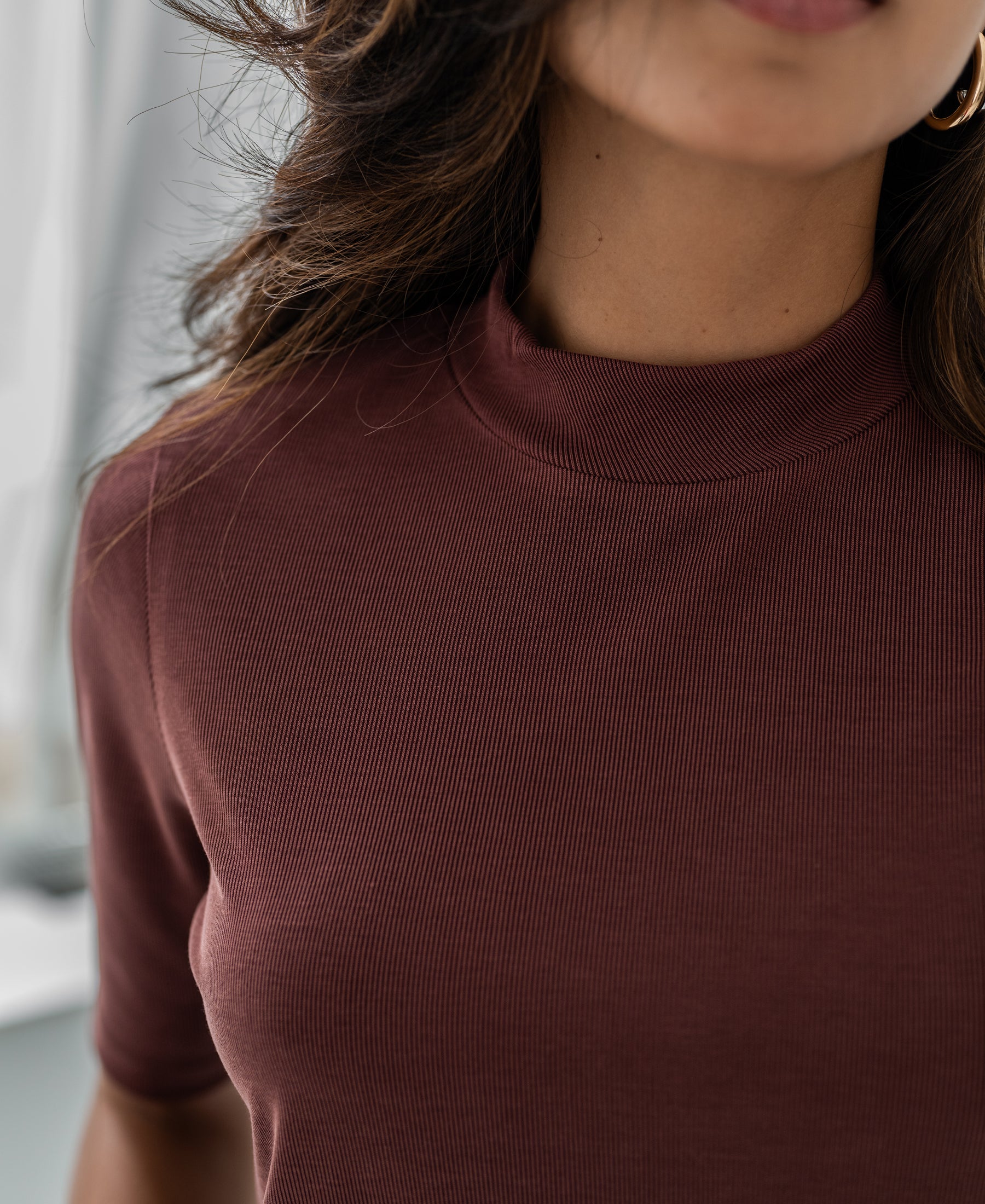 Maroon mock-neck ribbed short-sleeve top made of cotton blend, shown from the front.