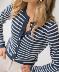 Striped cardigan in denim and ivory, shown from shoulders down.