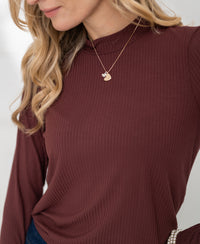 Ribbed maroon bamboo turtleneck top with a large collar, shown on a woman.