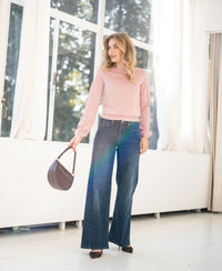 Pink boat neck sweater from PLEIN PUBLIQUE worn by a woman in a bright room.