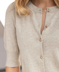 Short-sleeved beige-gold cardigan from Plein Publique, shown from the front.