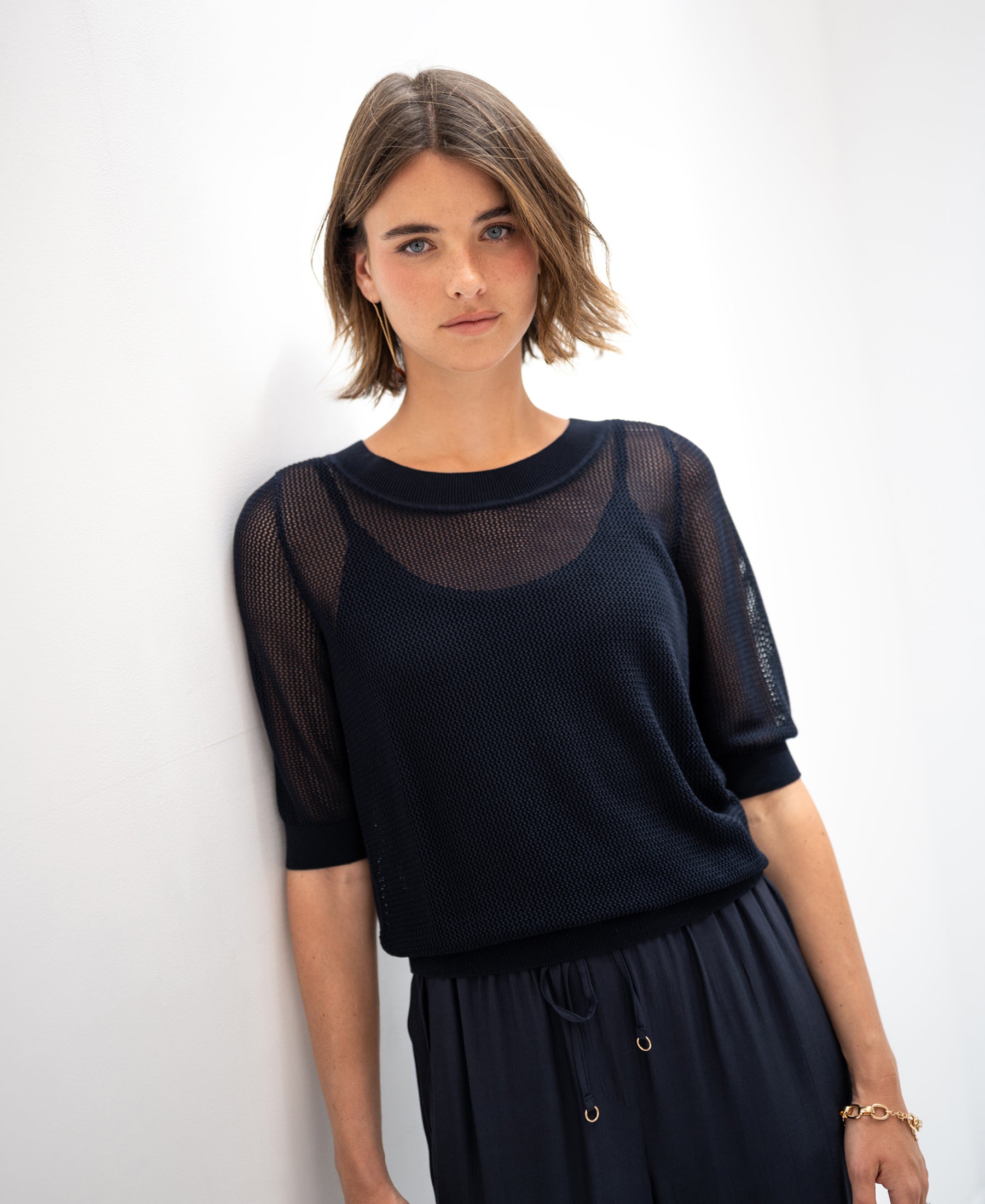 Dark blue PLEIN PUBLIQUE mesh sweater with silk, shown against a white wall.