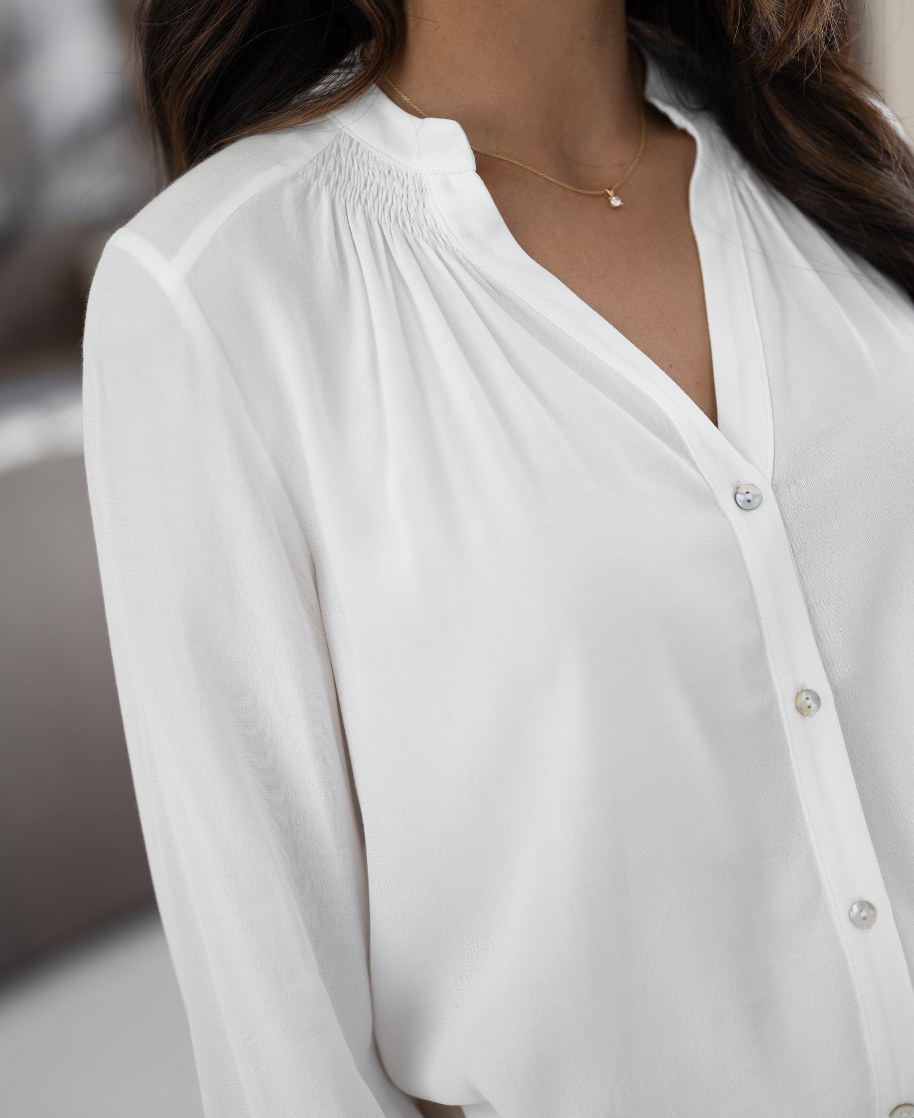 White blouse with smock details from Plein Publique, called LA NIMES, shown worn by a model.