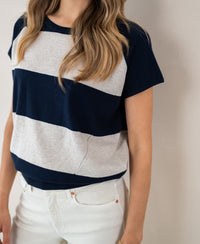 Woman wearing a PLEIN PUBLIQUE striped sweater LA PALOISE in dark blue and sand.