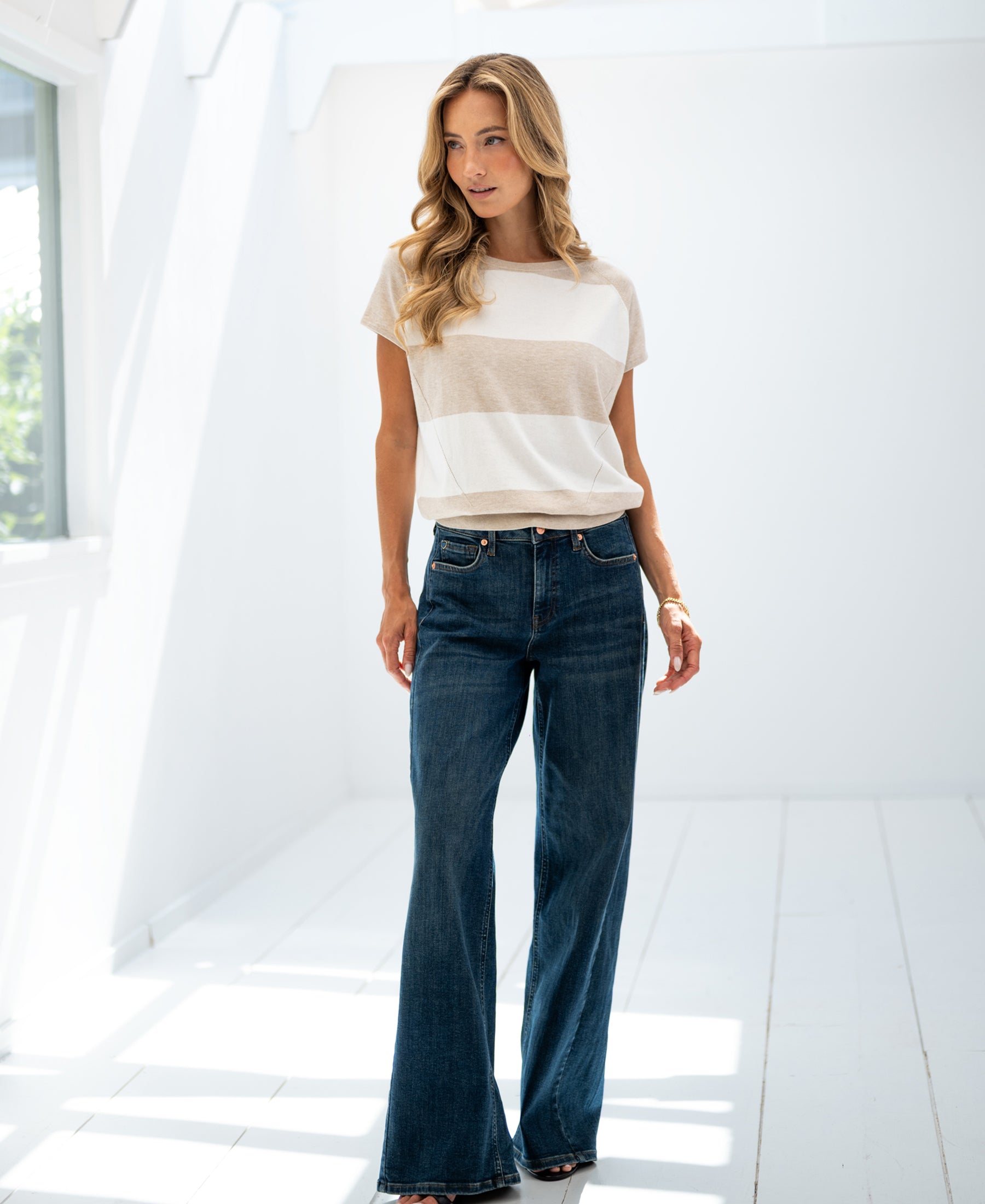 Striped sweater LA PALOISE by PLEIN PUBLIQUE shown in a bright room, side view.