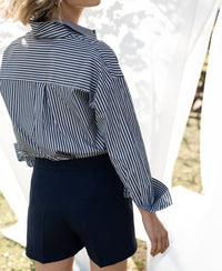 Navy blue PLEIN PUBLIQUE LA MADDY shorts, worn outdoors for a breezy summer vibe.