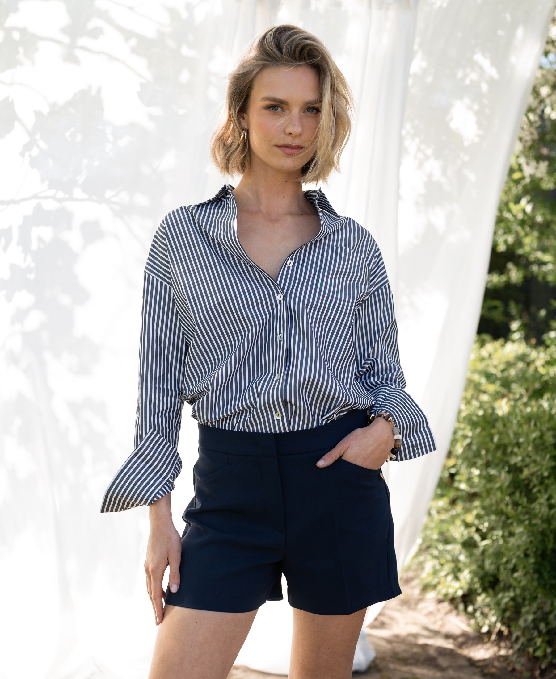 Navy blue LA MADDY shorts by PLEIN PUBLIQUE displayed outdoors.