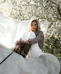 Brown and ivory striped Tencel blouse by PLEIN PUBLIQUE, LA PASCALLE style, worn by a woman seated on a white horse.
