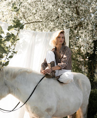 PLEIN PUBLIQUE Tencel blouse in brown-ivory stripes, shown outdoors.