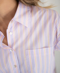 Close-up of the Pascale blouse: multicolor stripes, soft cotton, oversized fit, and single pocket.