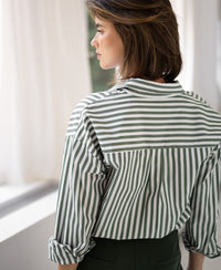 Back view of PLEIN PUBLIQUEs LA PASCALLE white-olive green striped blouse, shown indoors.