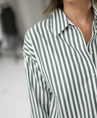 The PLEIN PUBLIQUE LA PASCALLE blouse in white and olive-green stripes, shown from the shoulders down.