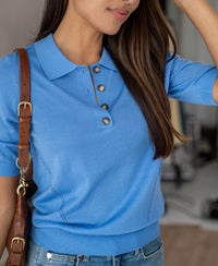Woman in a lavender blue Merino-silk polo by PLEIN PUBLIQUE, smiling.