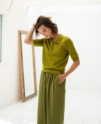 Woman wearing the LE PAULY Olive Green Merino Silk Polo by PLEIN PUBLIQUE.