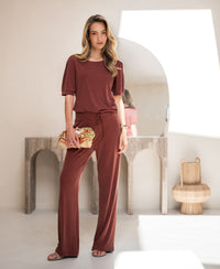 Henna-colored lounge pants in a modern, minimalist room.