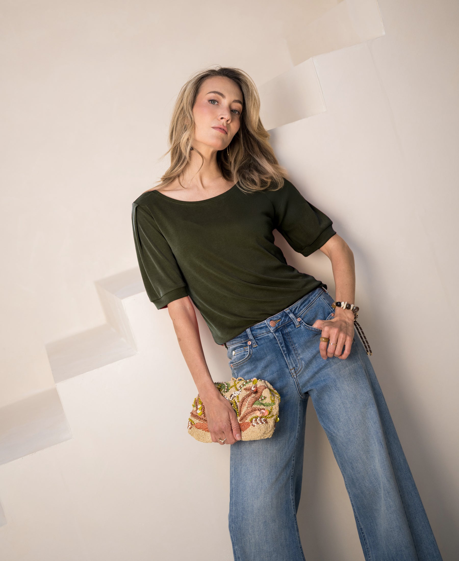 Olive green ribbed T-shirt with short sleeves, shown on a model.