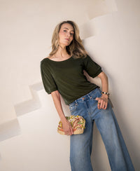 Olive green ribbed T-shirt with short sleeves, shown on a model.