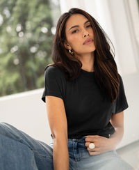 Charcoal ribbed knit top with collar, shown worn indoors.