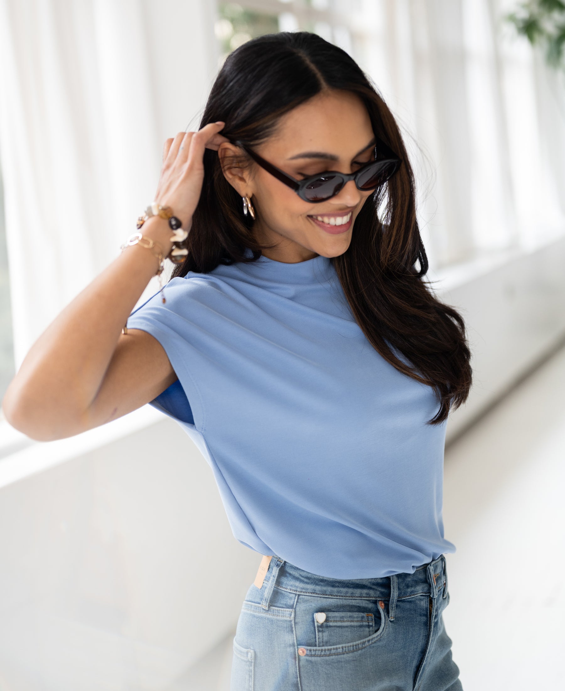 Light blue ribbed collared top, front view.
