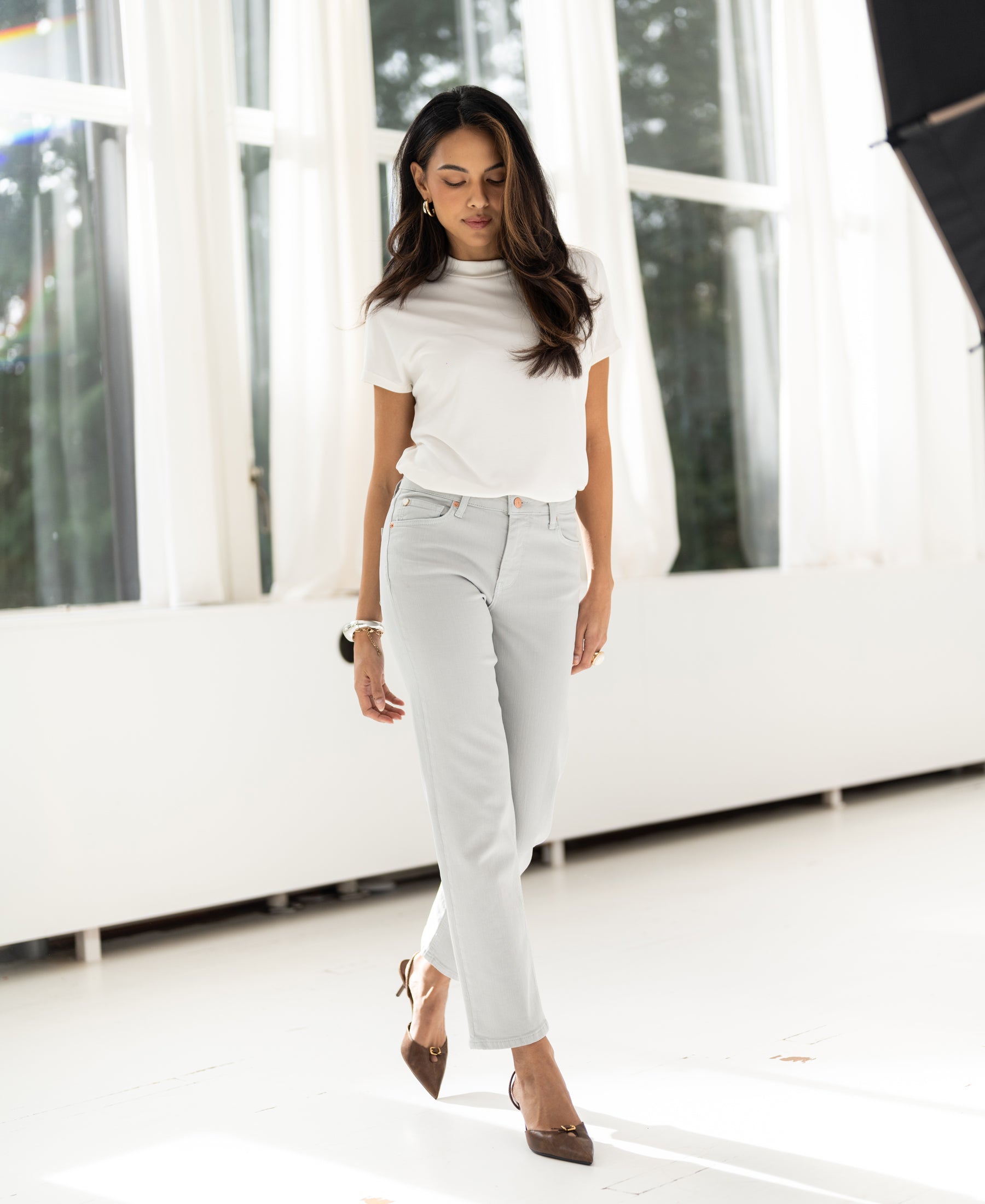Ivory ribbed knit top by PLEIN PUBLIQUE, shown worn in a bright, sunlit room.