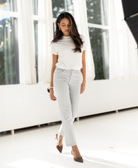 Ivory ribbed knit top by PLEIN PUBLIQUE, shown worn in a bright, sunlit room.