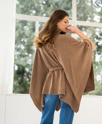 Camel merino wool poncho with belt by PLEIN PUBLIQUE, shown from the side.
