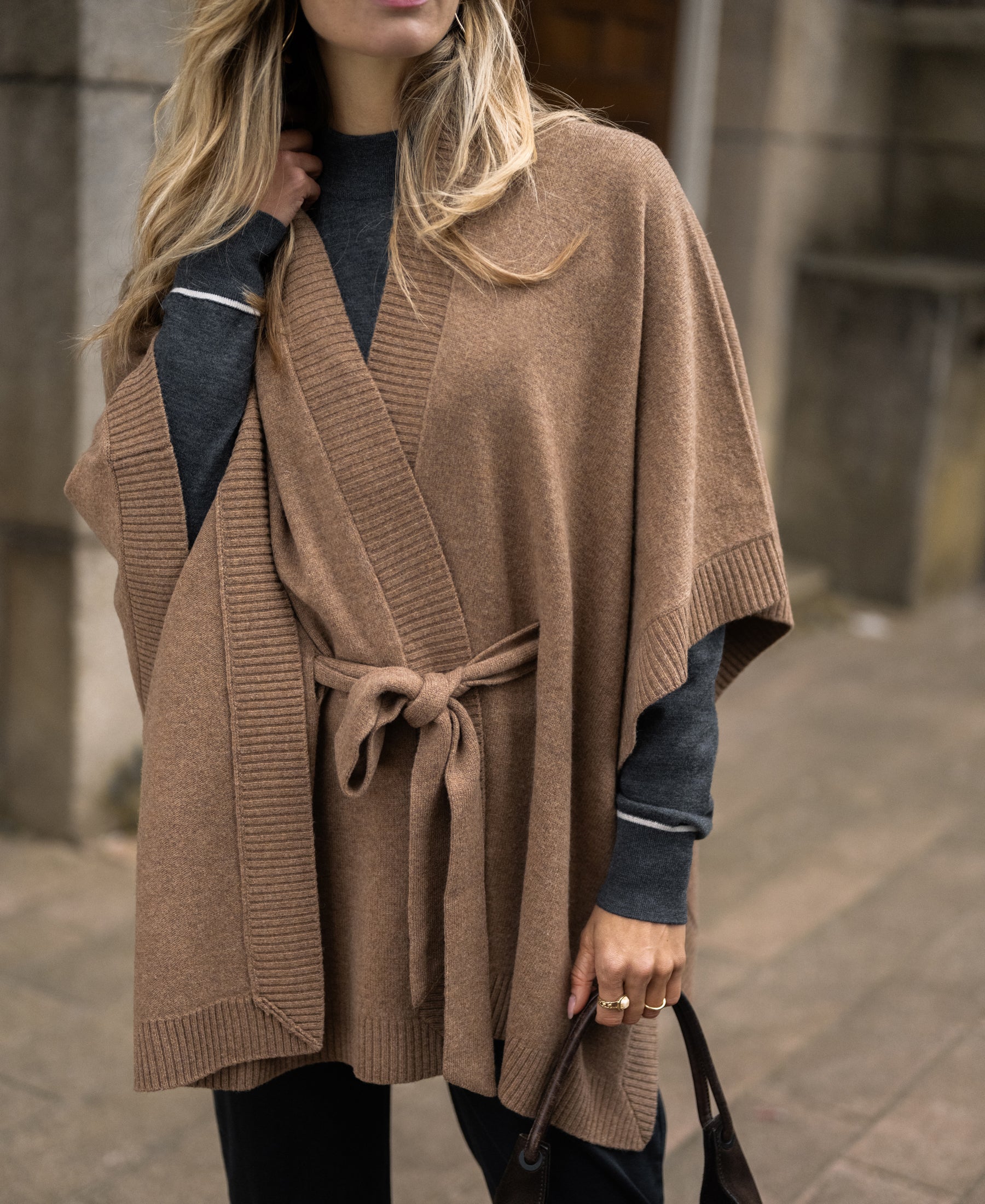 Camel merino wool poncho cape shown on a woman outdoors.