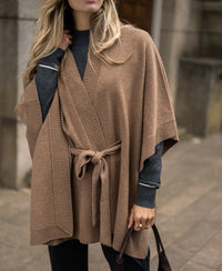 Camel merino wool poncho cape shown on a woman outdoors.