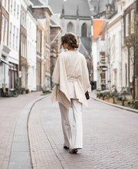 Light sand-colored merino wool poncho from Plein Publique.