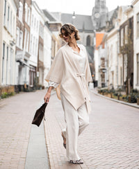 Light sand merino wool poncho by PLEIN PUBLIQUE.
