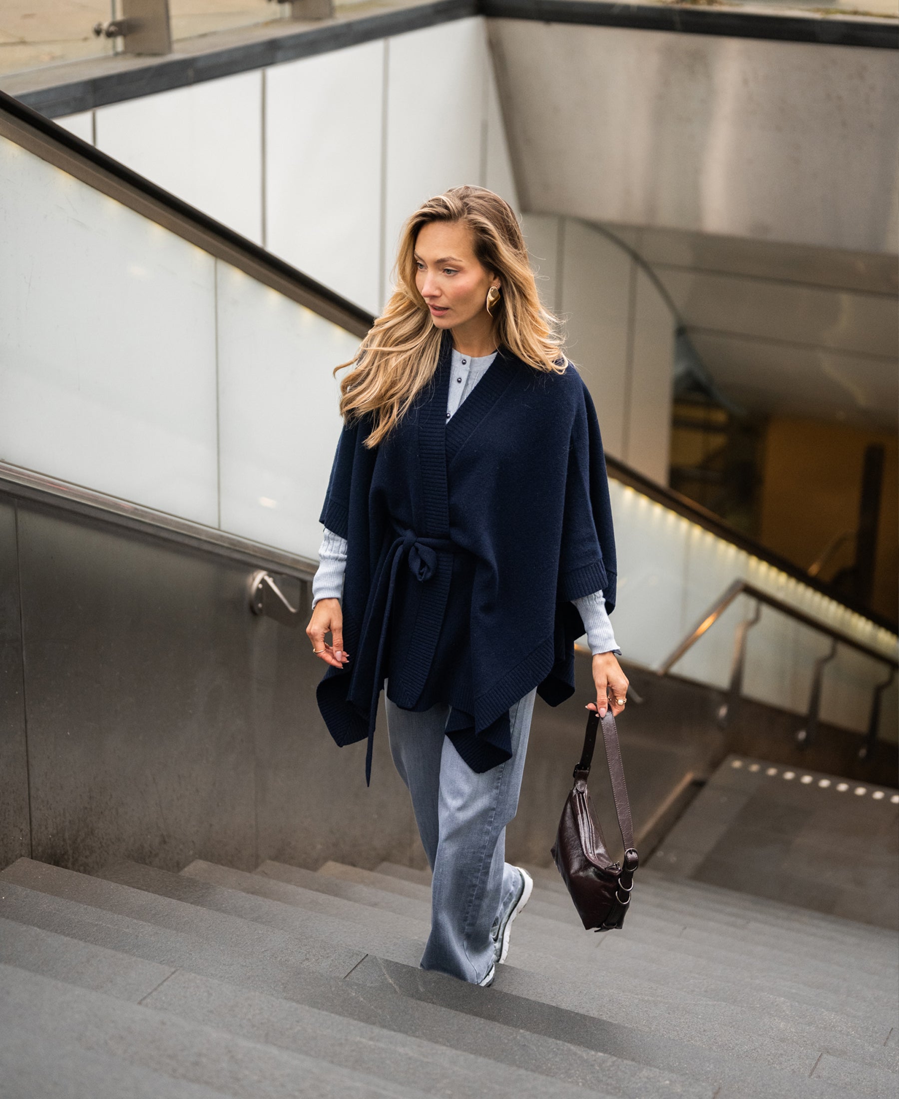 Dark blue merino wool poncho by PLEIN PUBLIQUE, shown from the front.
