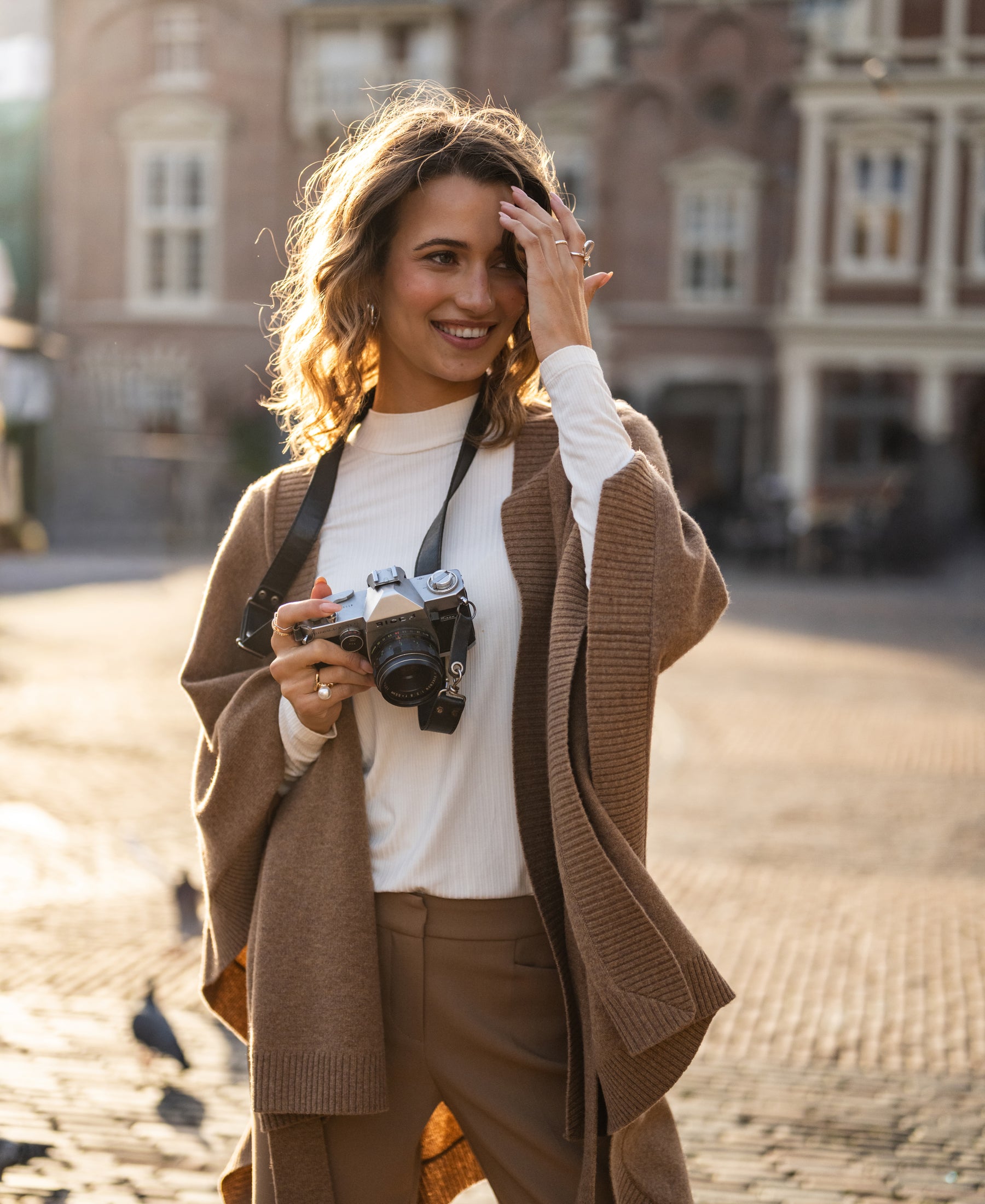 Camel-colored merino wool poncho shown in sunlight.