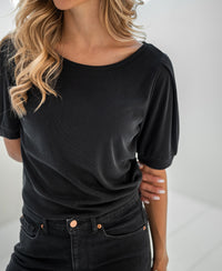Charcoal ribbed T-shirt in LA PHILEINE style, shown with arm behind back.