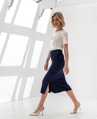 Navy blue PLEIN PUBLIQUE LE MAEL travel skirt shown indoors in natural light.