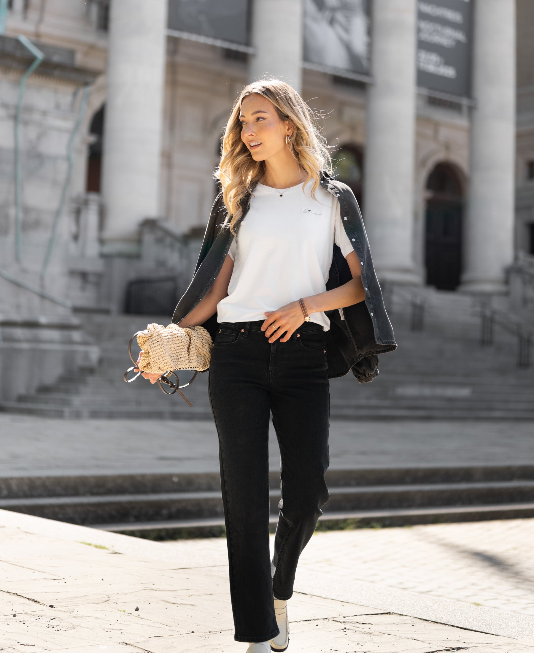 Black cropped jeans, ankle length, modeled outdoors.