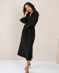 Black LE RAPHAEL button-down dress by PLEIN PUBLIQUE, shown against a light wall.