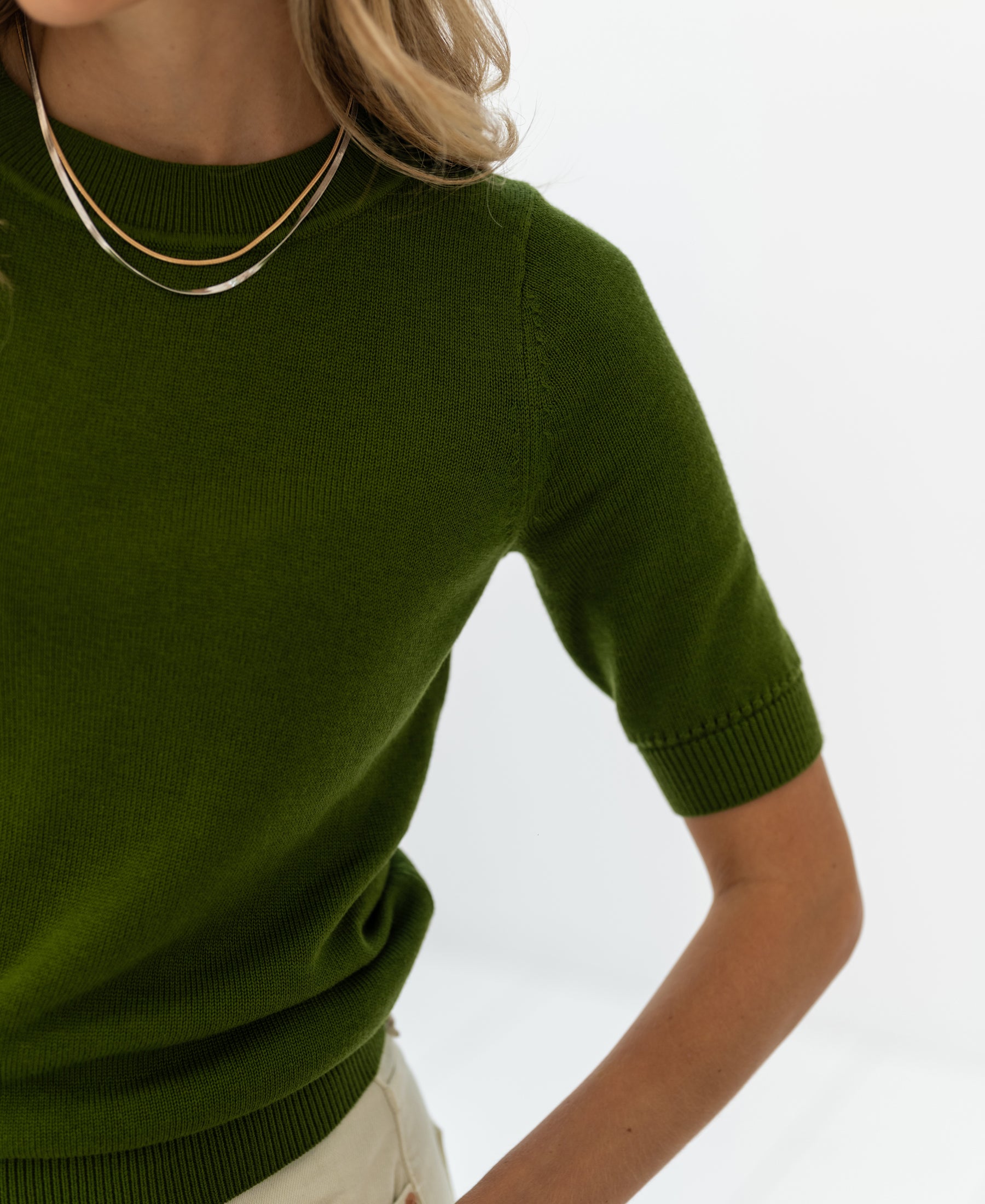 Olive green LA REVE sweater by PLEIN PUBLIQUE against a white background.