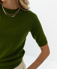 Olive green LA REVE sweater by PLEIN PUBLIQUE against a white background.