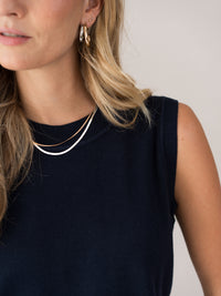 Woman wearing a dark blue PLEIN PUBLIQUE Spencer LE REVEIL cardigan.