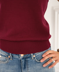 Dark red PLEIN PUBLIQUE cardigan Spencer LE REVEIL shown worn, hand on hip.