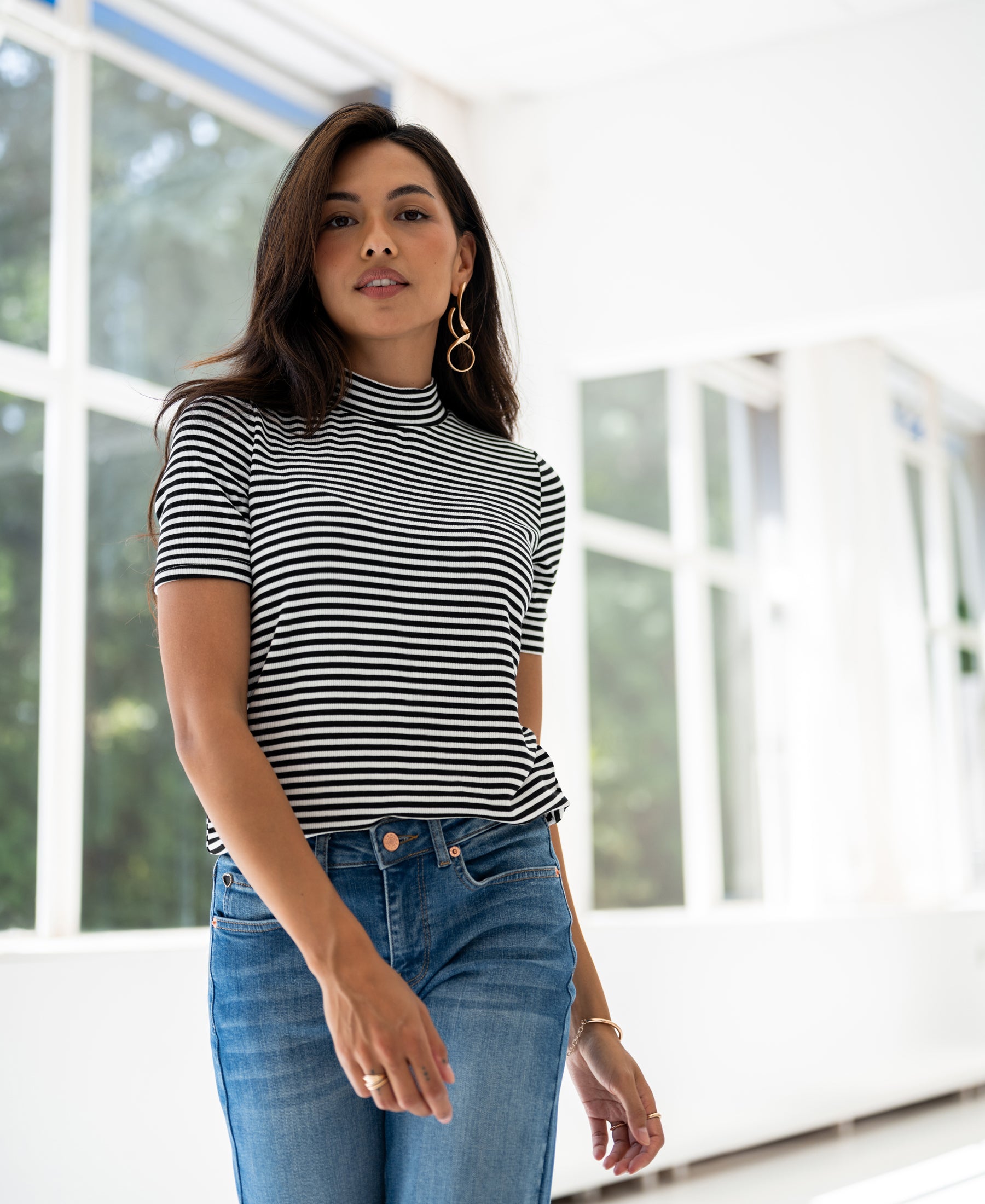 White and black ribbed collar top LA RIXY by PLEIN PUBLIC, shown indoors near large windows.